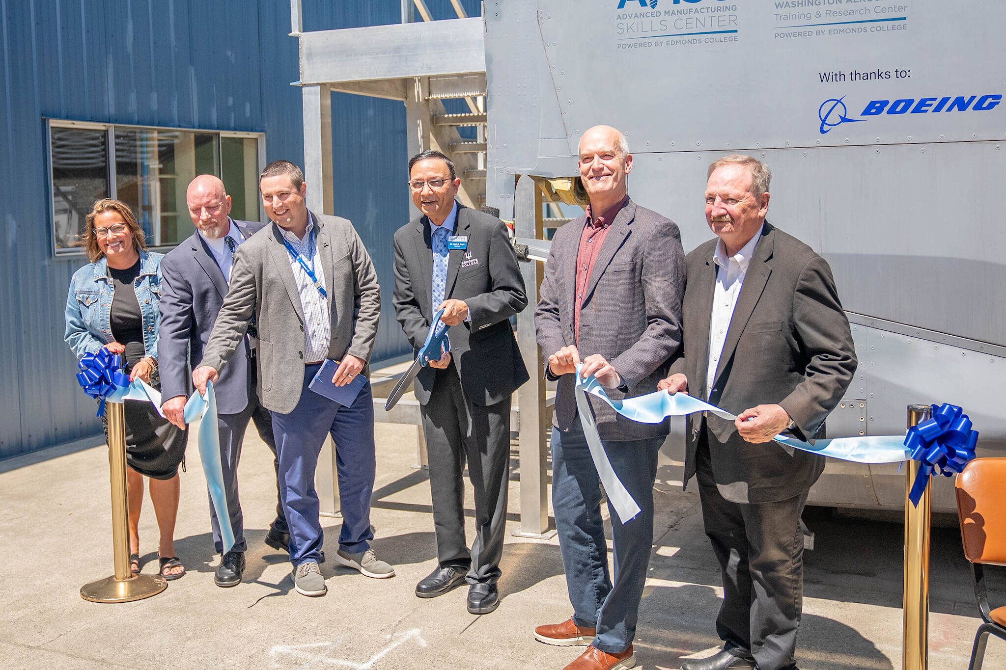 Everett Mayor Cassie Franklin, Advanced Manufacturing Skills Center executive director Larry Cluphf, Boeing Director of manufacturing and safety Cameron Myers, Edmonds College President Amit Singh, U.S. Rep. Rick Larsen, and Snohomish County Executive Dave Somers participate in a ribbon-cutting ceremony on Tuesday, July 2 celebrating the opening of a new fuselage training lab at Paine Field. Credit: Arutyun Sargsyan / Edmonds College