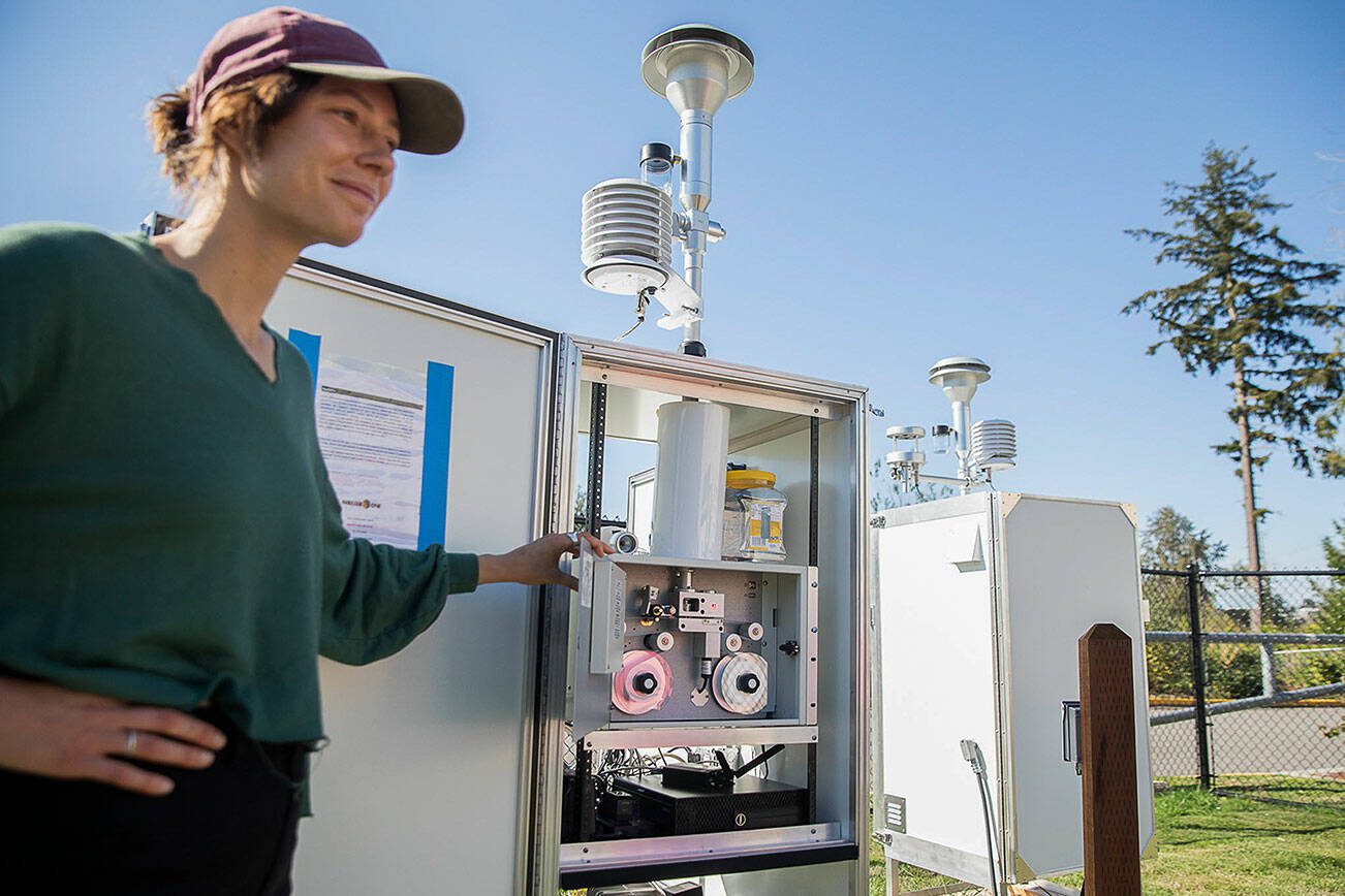 Kate Miller, an air monitoring specialist with the Department of Ecology, shows the inside of a PM10 air monitor installed outside of Fairmount Elementary School on Thursday, Sept. 5, 2024 in Everett, Washington. (Olivia Vanni / The Herald)