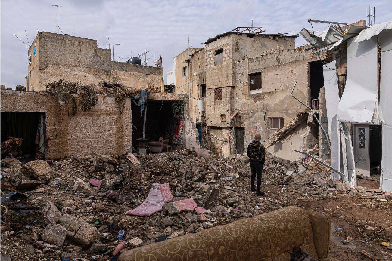 A man surveys the damage after clashes at a refugee camp in Jenin, in the Israeli-occupied West Bank on Dec. 7, 2023. (Afif Amireh/The New York Times)