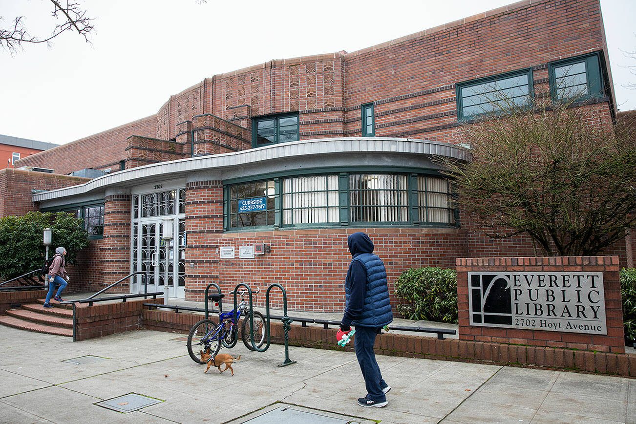 People walk into the Everett Library off of Hoyt Avenue on Tuesday, Dec. 3, 2024 in Everett, Washington. (Olivia Vanni / The Herald)