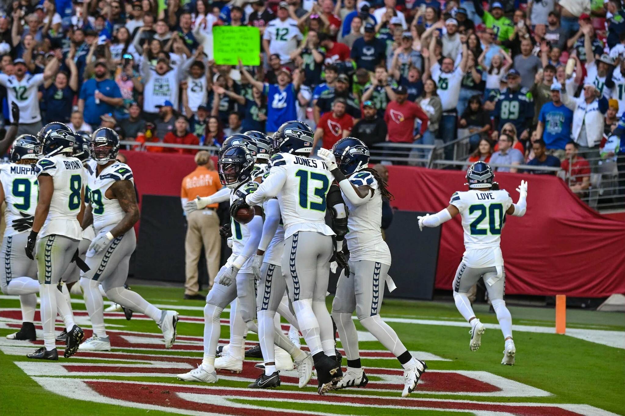 Seahawks linebacker Ernest Jones IV (13) celebrates his interception with teammates in a 30-18 win over Arizona at State Farm Stadium on Sunday, Dec. 8, 2024. (Photo courtesy of Edwin Hooper / Seattle Seahawks)