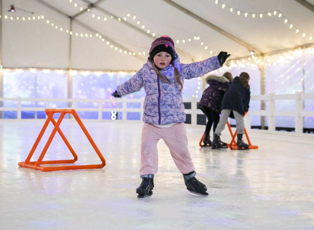 Lincoln Shull, 5, tries out skating across the ice without the help of a skate trainer at the ice rink set up at Tulalip Lights & Ice on Wednesday, Dec. 4, 2024 in Tulalip, Washington. (Olivia Vanni / The Herald)
